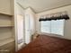 Bedroom featuring a comfortable bed, a window with blinds, and an exterior access door at 455 S Jaspar Dr, Apache Junction, AZ 85119