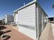 Property exterior with metal siding, brick patio, and desert landscaping at 455 S Jaspar Dr, Apache Junction, AZ 85119