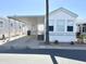 Charming mobile home with a spacious carport, well-maintained landscaping, and appealing exterior at 455 S Jaspar Dr, Apache Junction, AZ 85119