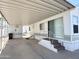 Mobile home featuring a large carport, multiple entry points, and a comfortable outdoor living space at 455 S Jaspar Dr, Apache Junction, AZ 85119