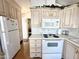 Bright kitchen with white appliances and plenty of storage at 455 S Jaspar Dr, Apache Junction, AZ 85119