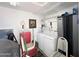 Organized laundry room with washer, dryer, storage cabinets, and ample space at 455 S Jaspar Dr, Apache Junction, AZ 85119