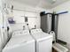 Functional laundry area equipped with washer, dryer, storage shelves, and utility connections at 455 S Jaspar Dr, Apache Junction, AZ 85119