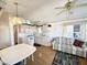 Bright, open living space featuring updated kitchen appliances and wood floors at 455 S Jaspar Dr, Apache Junction, AZ 85119