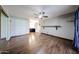 Cozy bedroom featuring wood floors, ceiling fan and closet with mirrored doors at 4916 E Hopi St, Phoenix, AZ 85044