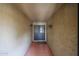 Covered entryway featuring a textured wall finish and double doors, creating a welcoming entrance at 4916 E Hopi St, Phoenix, AZ 85044