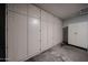 Garage featuring ample built-in storage cabinets along one wall, providing plenty of organizational space at 4916 E Hopi St, Phoenix, AZ 85044