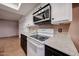 Well-lit kitchen featuring white upper cabinets and a stainless steel microwave at 4916 E Hopi St, Phoenix, AZ 85044