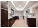 Modern kitchen with white cabinets, dark countertops, modern appliances, and tiled flooring at 4916 E Hopi St, Phoenix, AZ 85044