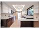 Renovated kitchen with white cabinets, granite countertops, modern appliances, and tile flooring at 4916 E Hopi St, Phoenix, AZ 85044