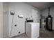 Functional laundry room with washing machine, water heater, and plenty of space for laundry tasks at 4916 E Hopi St, Phoenix, AZ 85044