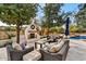Luxurious outdoor space with a stone fireplace, comfortable seating, and a sparkling swimming pool at 5112 N 41St St, Phoenix, AZ 85018
