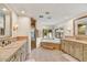 Luxurious bathroom featuring dual vanities, a soaking tub, and a separate shower at 5112 N 41St St, Phoenix, AZ 85018