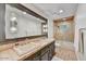 Well-lit bathroom featuring double sinks, a vanity, a shower/tub, and ceramic tile at 5112 N 41St St, Phoenix, AZ 85018