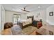 Bright bedroom features a large window, ceiling fan, and access to the backyard through french doors at 5112 N 41St St, Phoenix, AZ 85018