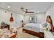 Cozy bedroom features hardwood floors, a ceiling fan, and natural light from the exterior window at 5112 N 41St St, Phoenix, AZ 85018