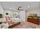 Cozy bedroom featuring light hardwood floors, a ceiling fan, and access to the exterior at 5112 N 41St St, Phoenix, AZ 85018
