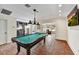 Large game room with a billiard table, bar area, brick floors, and natural light at 5112 N 41St St, Phoenix, AZ 85018