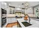 Bright kitchen features white cabinets, stainless steel appliances, and a marble island with a prep sink at 5112 N 41St St, Phoenix, AZ 85018