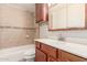 Bathroom featuring tiled walls, wood cabinets, and a shower over tub at 5525 N 21St Ave, Phoenix, AZ 85015