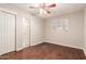 A bedroom features wood flooring, a ceiling fan, and a closet at 5525 N 21St Ave, Phoenix, AZ 85015