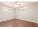 A bedroom with wood flooring, a ceiling fan, and window shutters at 5525 N 21St Ave, Phoenix, AZ 85015