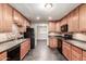 Kitchen features wood cabinets, black appliances and decorative backsplash at 5525 N 21St Ave, Phoenix, AZ 85015