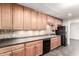 Updated kitchen with wood cabinets, black appliances and decorative backsplash at 5525 N 21St Ave, Phoenix, AZ 85015