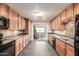 Bright kitchen with wood cabinets, black appliances and backyard access at 5525 N 21St Ave, Phoenix, AZ 85015