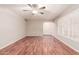 Spacious living room featuring wood floors, neutral walls, ceiling fan and large window at 5525 N 21St Ave, Phoenix, AZ 85015