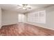 Living room with hardwood floors, ceiling fan, and window with plantation shutters at 5525 N 21St Ave, Phoenix, AZ 85015