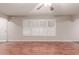 Bright living room with wood floors and large window with white wood-look shutters at 5525 N 21St Ave, Phoenix, AZ 85015