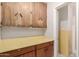 Pantry with wall and base cabinets plus a doorway leading to a yellow tiled room at 5525 N 21St Ave, Phoenix, AZ 85015