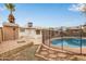 Backyard pool area with safety fence, patio, mature tree and view of home's back exterior at 5525 N 21St Ave, Phoenix, AZ 85015