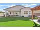 Expansive backyard boasts lush artificial turf, a covered patio, a pergola, and offers great entertaining space at 5650 S Feliz --, Mesa, AZ 85212
