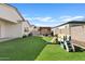 Spacious backyard featuring artificial grass, patio, pergola with outdoor kitchen, and play structure for  at 5650 S Feliz --, Mesa, AZ 85212