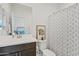 Well-appointed bathroom with a single vanity, modern fixtures, and a shower with decorative curtains at 5650 S Feliz --, Mesa, AZ 85212