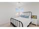 Charming bedroom with a black metal bed frame, plush bedding, and a bright and airy feel at 5650 S Feliz --, Mesa, AZ 85212