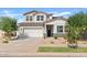 Charming two-story home featuring a two car garage, manicured landscaping, and inviting front entrance at 5650 S Feliz --, Mesa, AZ 85212