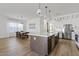 Open kitchen with island seating, modern appliances, and adjacent dining area at 5650 S Feliz --, Mesa, AZ 85212