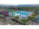 Community pool featuring a large main pool, splash pad, cabanas, lounge chairs, and water slides for enjoyment at 5650 S Feliz --, Mesa, AZ 85212