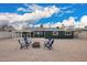 Enjoy an expansive backyard with a covered patio, a rock groundcover, and a fire pit and chairs at 6119 N 18Th Dr, Phoenix, AZ 85015
