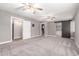 This large, carpeted bedroom has a ceiling fan and access to a bathroom and closet with a barn door at 6119 N 18Th Dr, Phoenix, AZ 85015