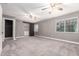 Large bedroom with gray carpet and paint, along with a walk in closet with barn door at 6119 N 18Th Dr, Phoenix, AZ 85015