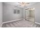 This bedroom features soft gray walls, plush carpet, a ceiling fan, and a mirrored closet door at 6119 N 18Th Dr, Phoenix, AZ 85015