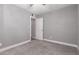 Empty bedroom with carpet, ceiling fan, and a door to another room at 6119 N 18Th Dr, Phoenix, AZ 85015