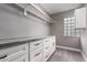 A large walk-in closet with shelving, drawers, and a countertop for storage and organization at 6119 N 18Th Dr, Phoenix, AZ 85015