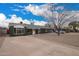 A single-story home showing the long driveway and desert landscaping, with plenty of parking space at 6119 N 18Th Dr, Phoenix, AZ 85015