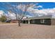 A single-story home showing the long side with desert landscaping, complemented by the well-kept street at 6119 N 18Th Dr, Phoenix, AZ 85015