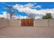 Wooden gate set within a block wall provides private access to the backyard at 6119 N 18Th Dr, Phoenix, AZ 85015